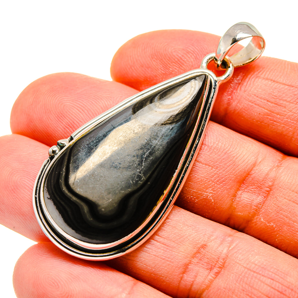 Sterling silver psilomelane pendant with dark teardrop stone, top bail visible