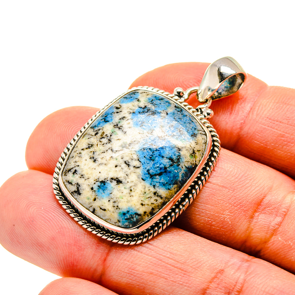Oval sterling silver pendant with blue azurite stone and scalloped bezel