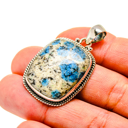 Oval sterling silver pendant with blue azurite stone and scalloped bezel