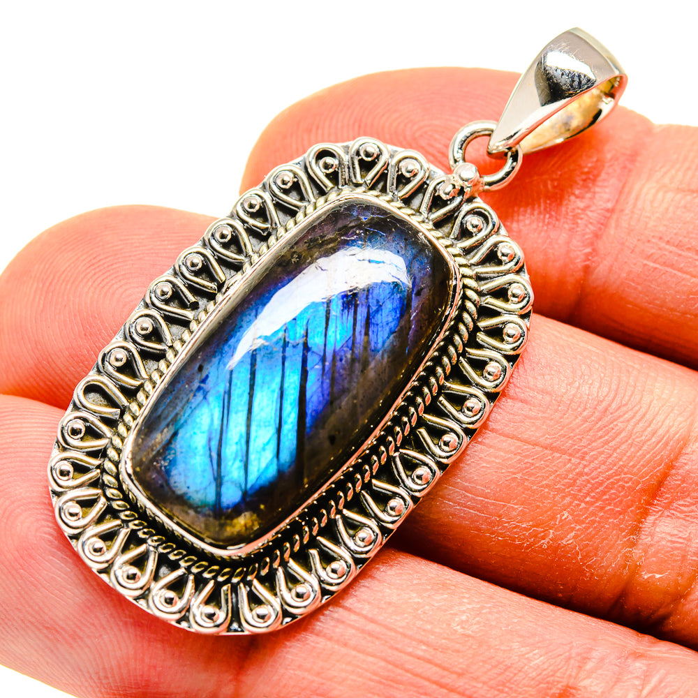Oval labradorite pendant with blue flash set in ornate 925 sterling silver frame