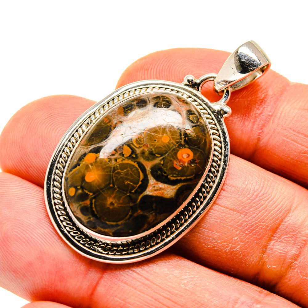 Silver-tone jasper pendant with round orange-brown cabochon and ornate bezel