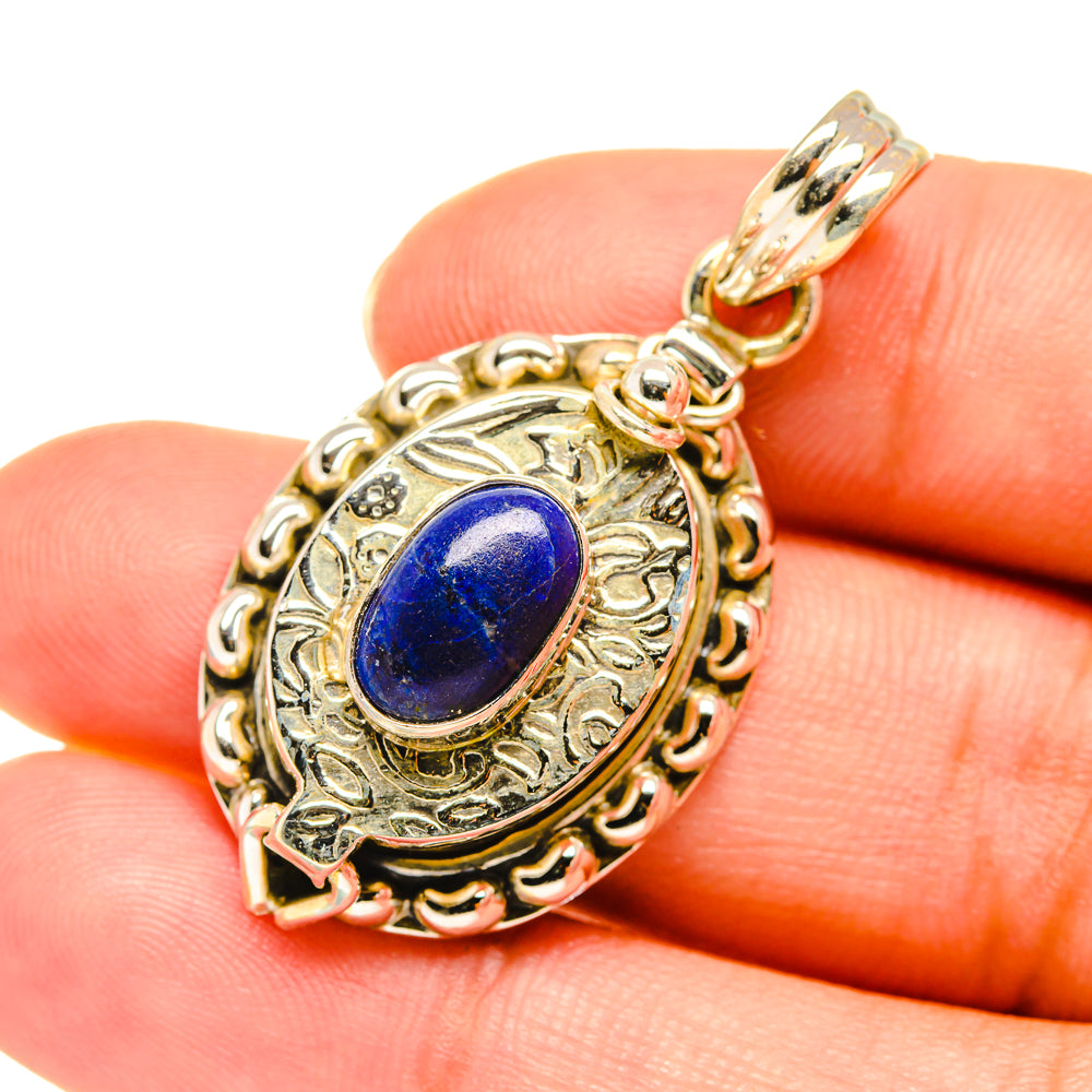 Lapis lazuli pendant close-up with ornate oval silver bezel and blue cabochon
