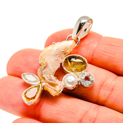 Geode pendant close-up with citrine center, pearl, and clear teardrop stones in silver