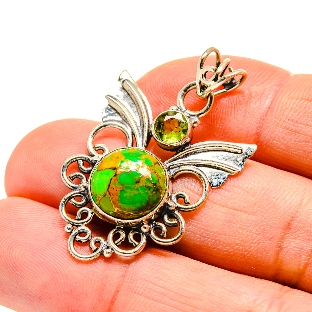 Round green gemstone pendant on leaf filigree, with small orange and green side stones