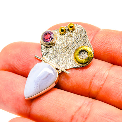 Stone pendant close-up with purple round gem, teardrop opal, textured gold-tone frame