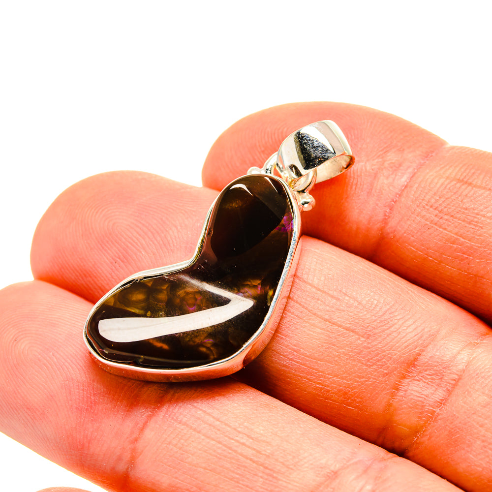 Heart-shaped fire agate pendant in sterling silver, polished bail and bezel setting