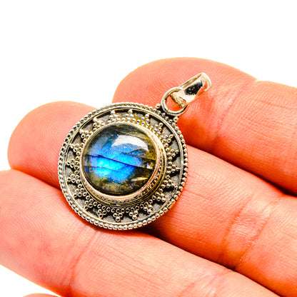 Sterling silver labradorite pendant with blue-green flash bezel setting, round frame