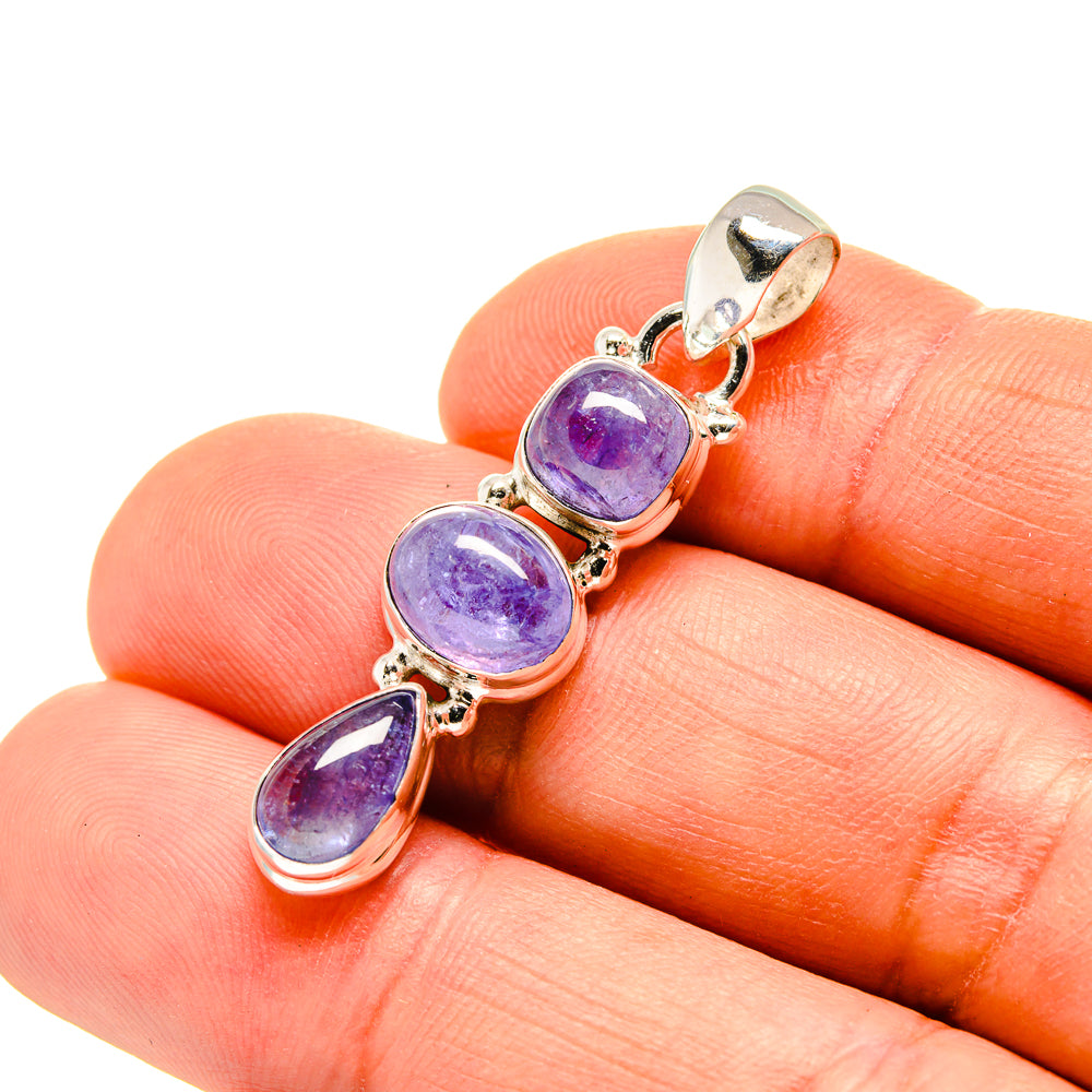 Close-up tanzanite pendant with three oval purple stones on sterling silver bail