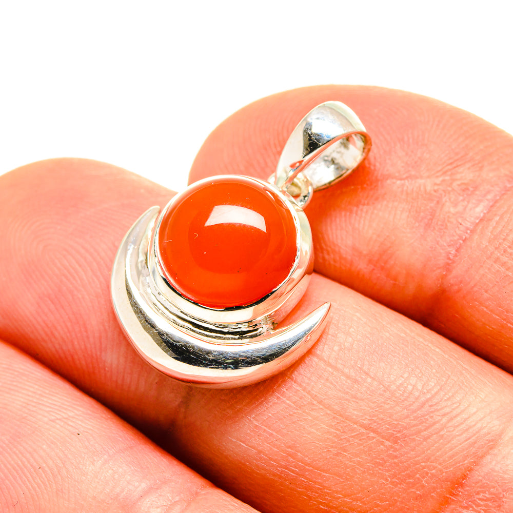 Red onyx pendant with round orange-red stone in silver crescent setting, bail loop