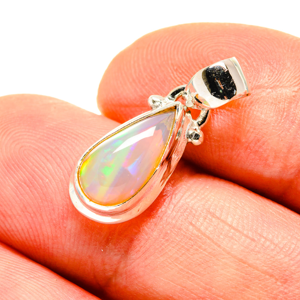 Sterling silver opal teardrop pendant with iridescent white opal and black bezel