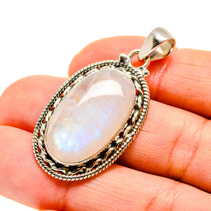 Oval moonstone pendant in 925 sterling silver with textured frame and bail