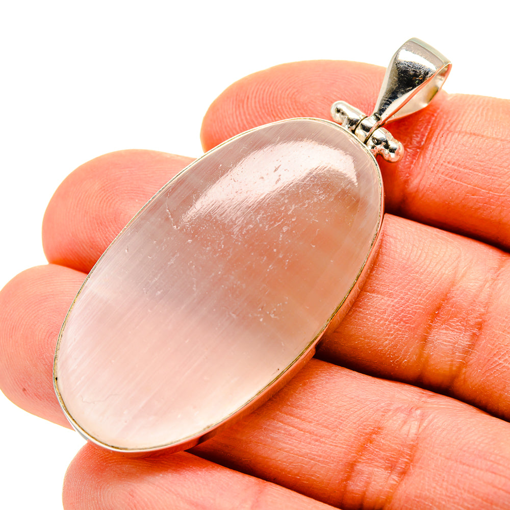 Oval moonstone pendant in sterling silver with pink sheen, small top bail