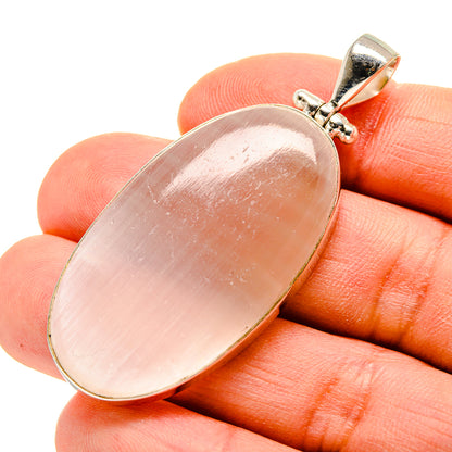 Oval moonstone pendant in sterling silver with pink sheen, small top bail