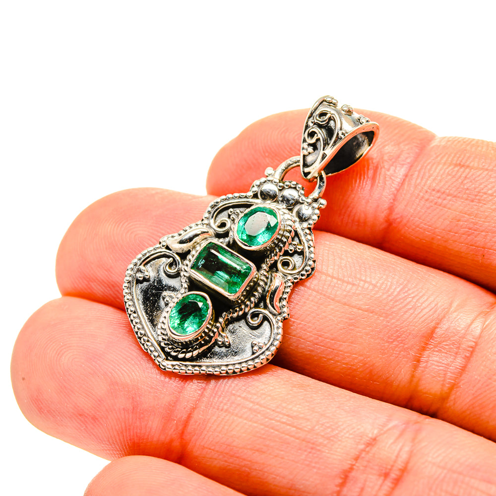 Sterling silver emerald pendant with three green gemstones, ornate filigree bezel.