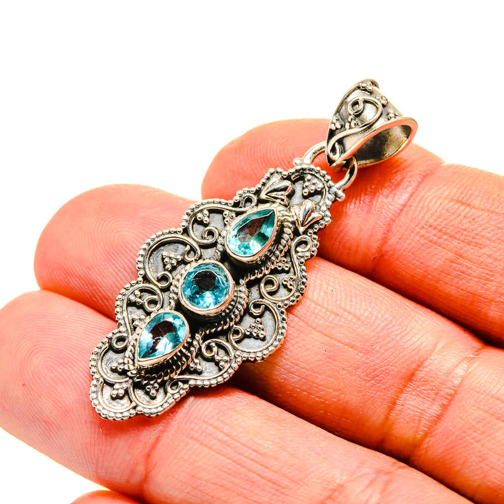 Sterling silver blue topaz pendant with ornate filigree and three teardrop stones