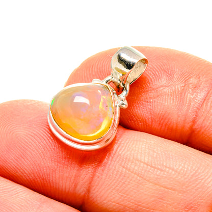 Sterling silver opal pendant with round orange opal in a hinged bail setting