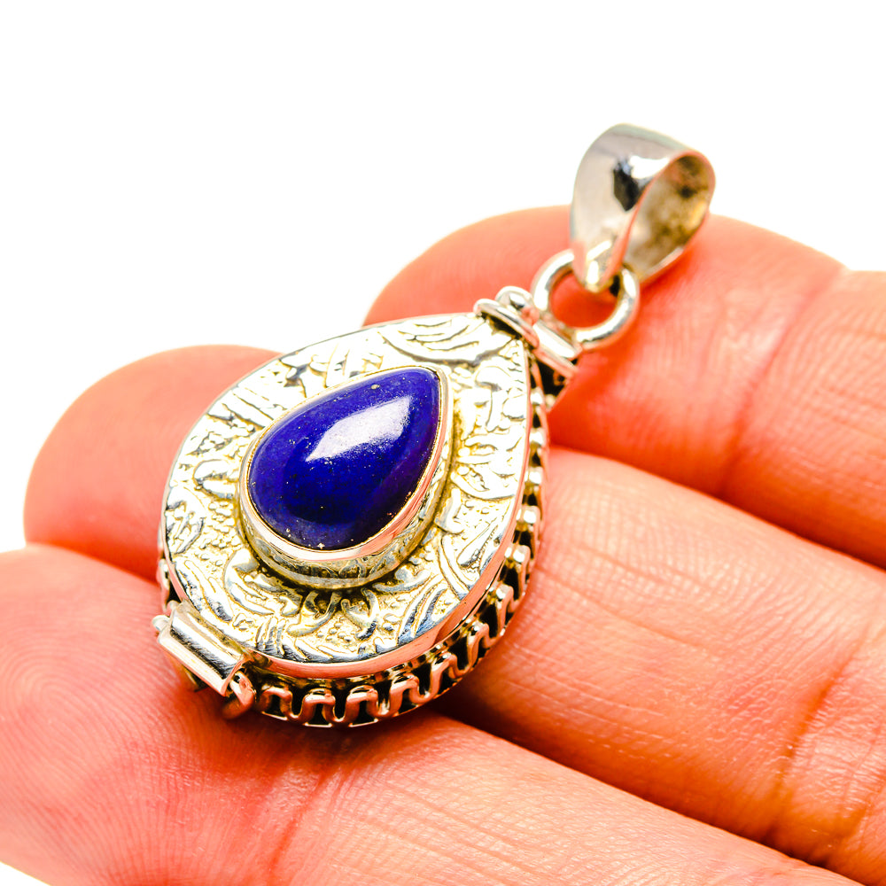 Teardrop lapis lazuli pendant with ornate silver setting and bail