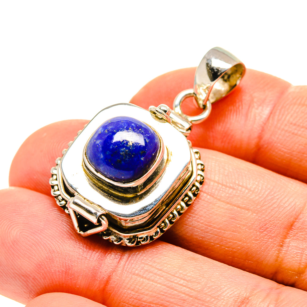Lapis lazuli poison pendant with blue cabochon in ornate silver-tone frame