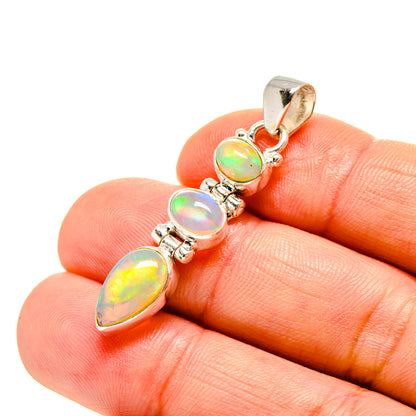 Sterling silver opal pendant with oval iridescent opals on bail, close-up