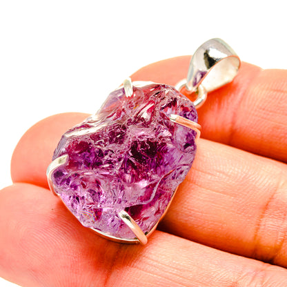 Sterling silver rough amethyst pendant with faceted purple stone, prong-set bail
