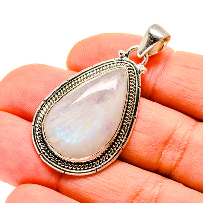 Sterling silver moonstone pendant teardrop with ornate frame, worn on finger