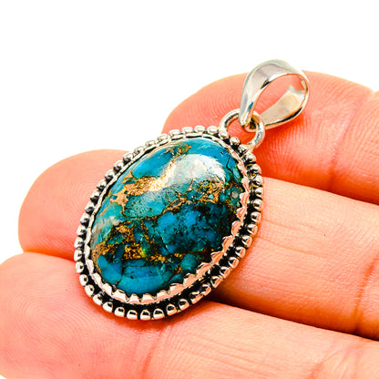Turquoise stone pendant with oval bezel and sterling silver bail, copper-look backing.