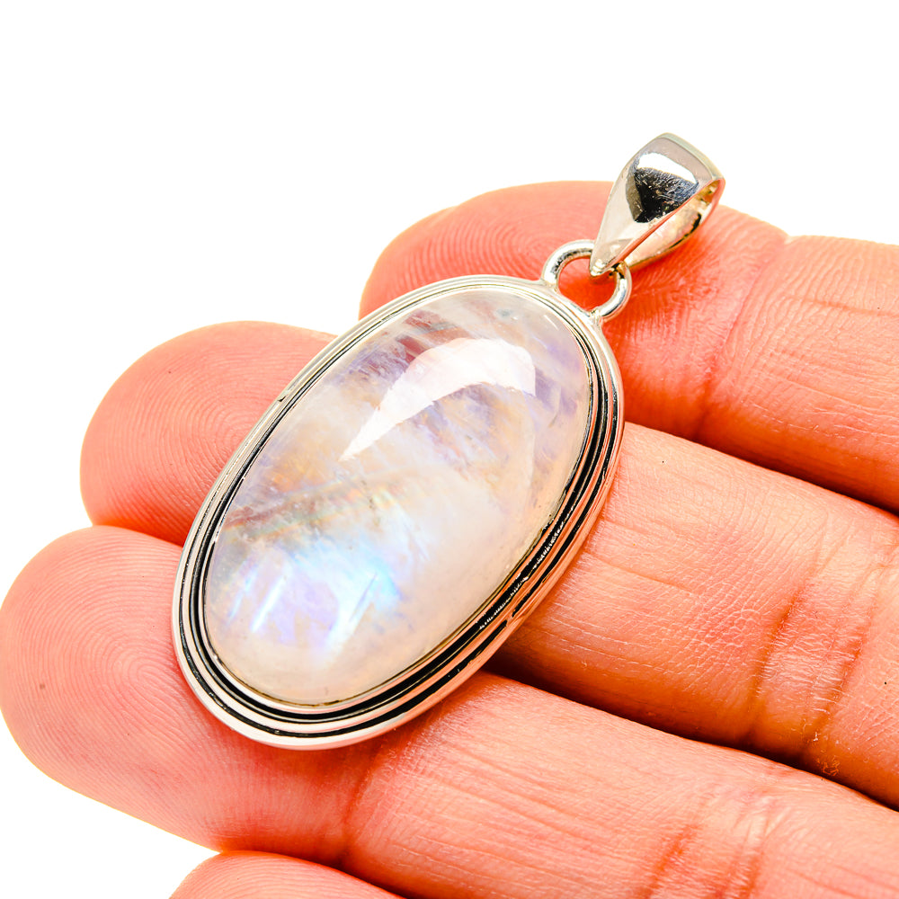 Oval moonstone pendant in silver setting with rainbow shimmer, with top bail