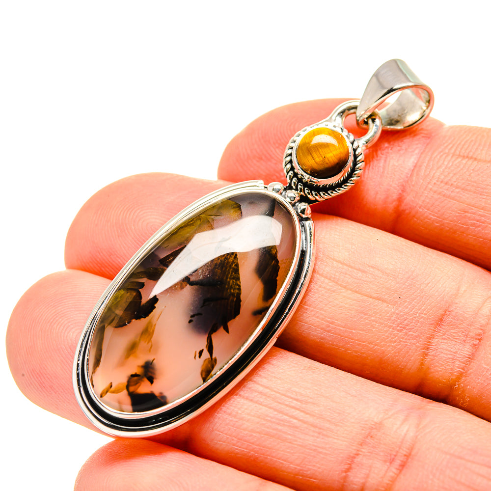Tiger eye oval pendant close-up on silver frame and loop bail