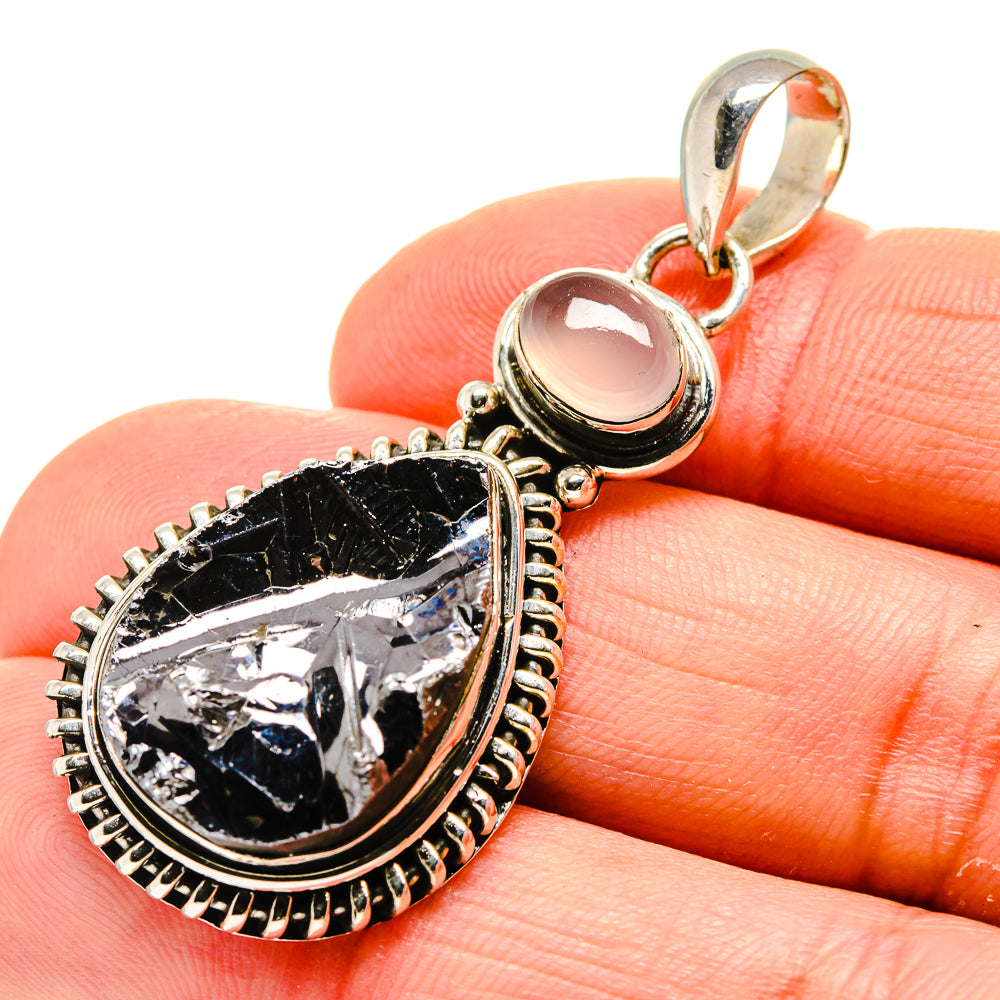 Sterling silver teardrop pendant with rough black stone and round pale pink stone bail