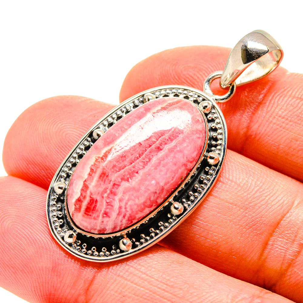 Oval rhodochrosite pendant, pink striped stone bezel in sterling silver