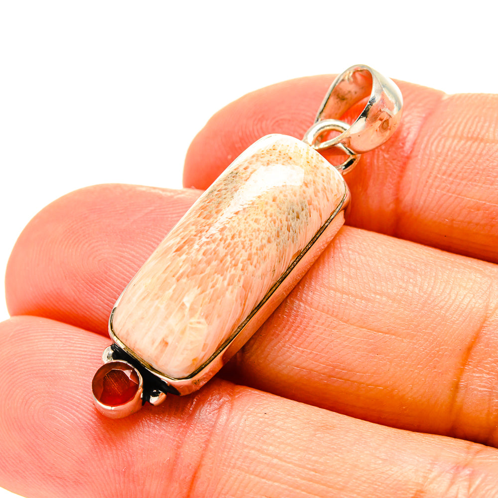 Scolecite and carnelian pendant with elongated stone and small round red gem in metal setting
