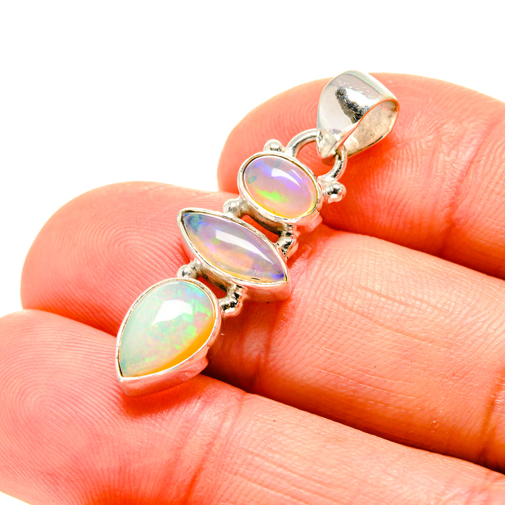 Sterling silver opal pendant with three iridescent oval stones, rainbow bezel settings