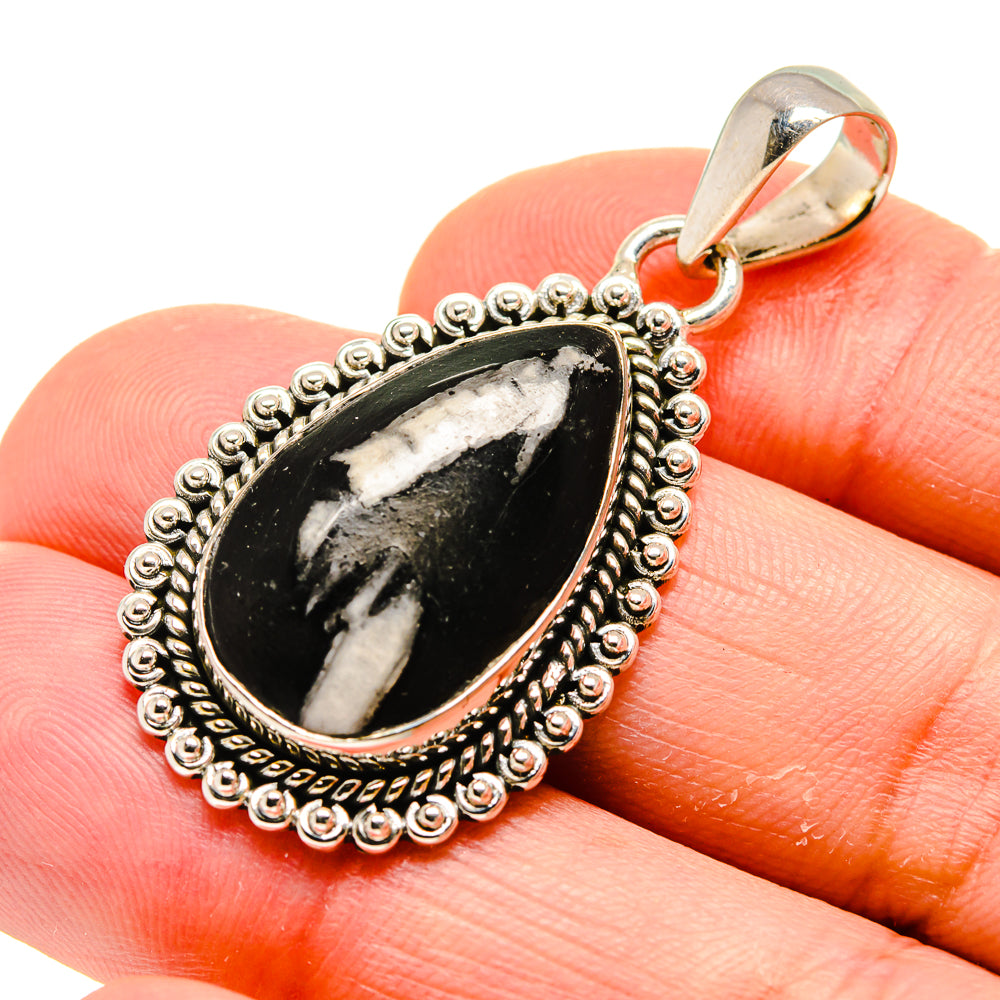 Teardrop gemstone pendant in black stone with ornate silver beaded border and bail