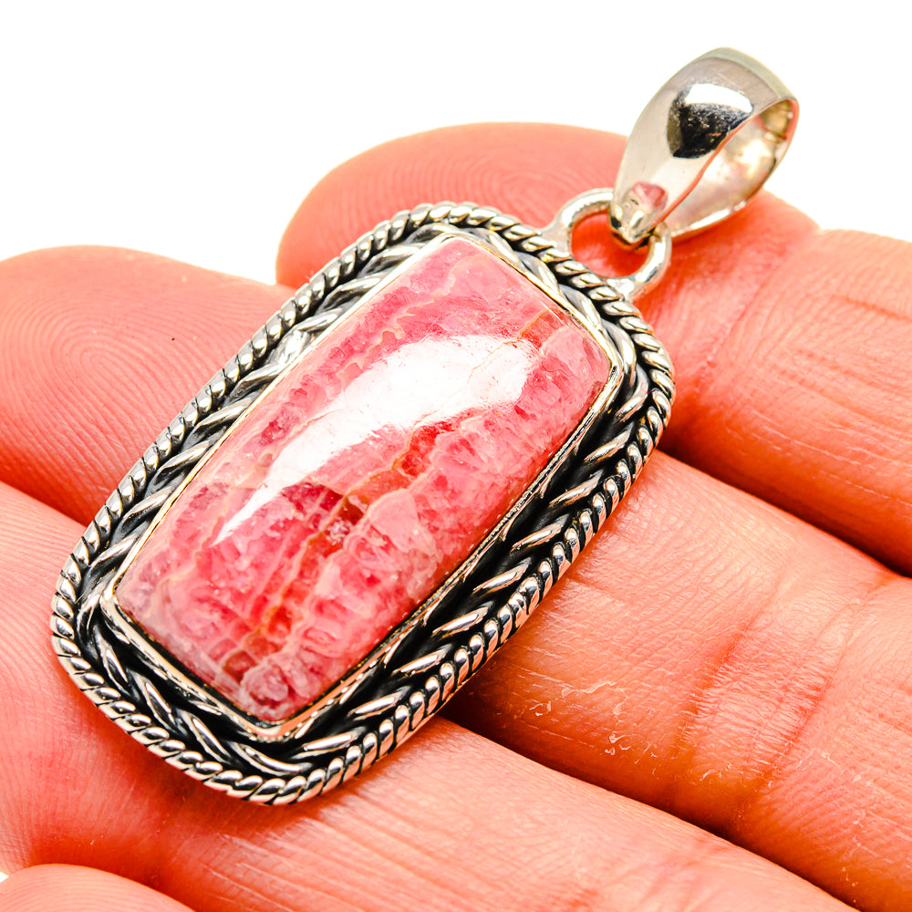 Rhodochrosite pendant close-up with pink striped rectangle stone in silver frame