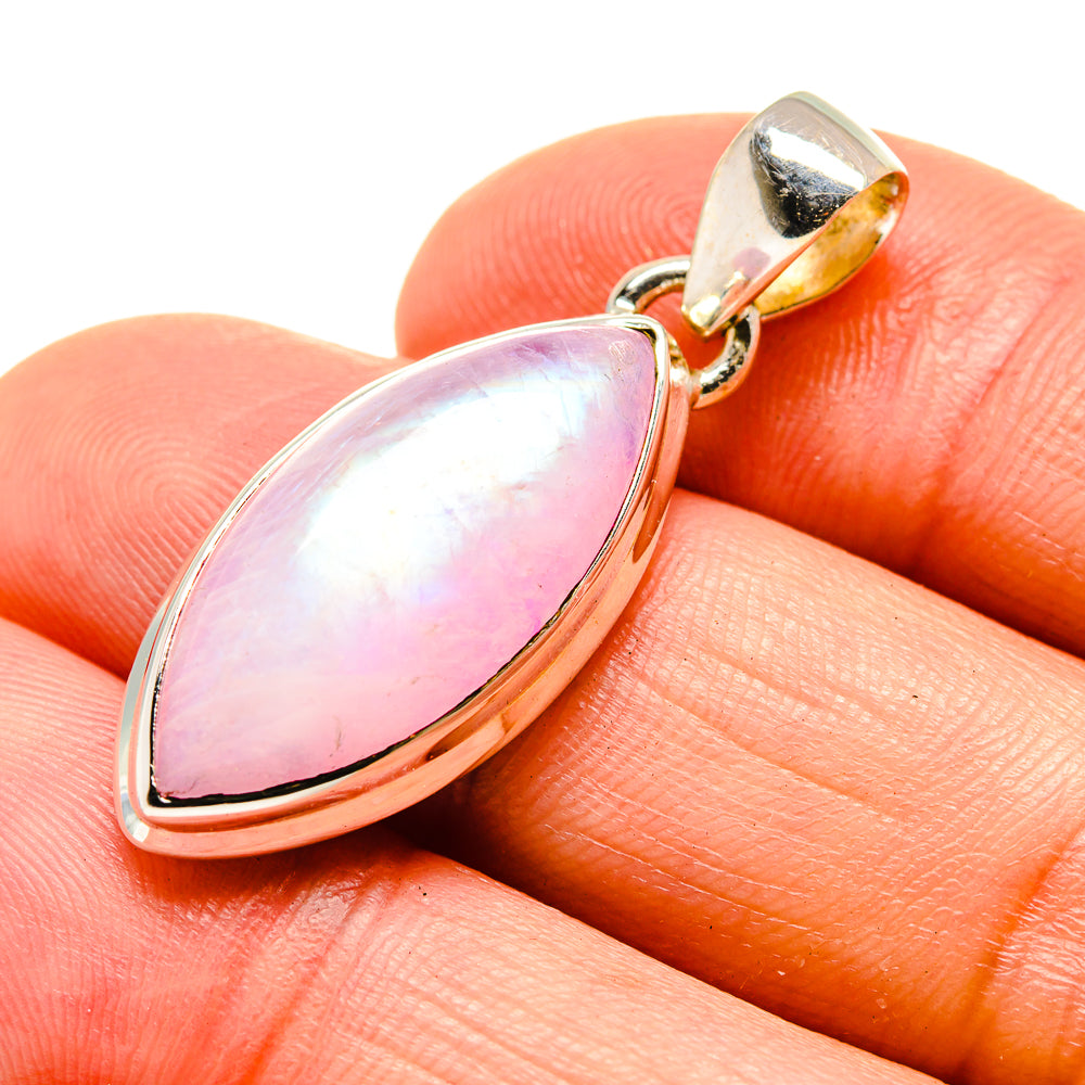 Pink moonstone pendant close-up, pear-shaped cabochon in gold-tone silver setting