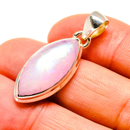 Pink moonstone pendant close-up, pear-shaped cabochon in gold-tone silver setting