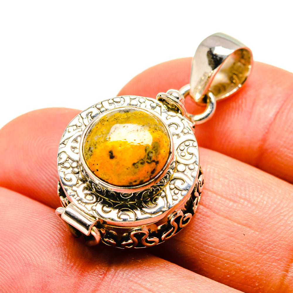 Round yellow jasper cabochon sterling silver pendant with ornate bezel and loop bail