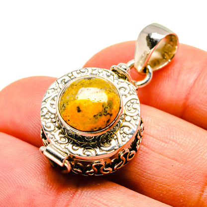 Round yellow jasper cabochon sterling silver pendant with ornate bezel and loop bail