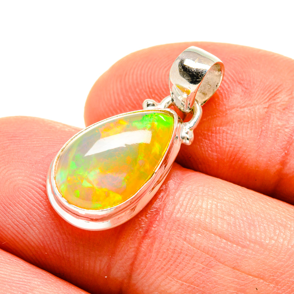 Sterling silver opal pendant close-up, oval opal with bright green-yellow flash