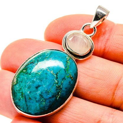 Chrysocolla oval gemstone and pale moonstone cabochon pendant in silver setting, close-up