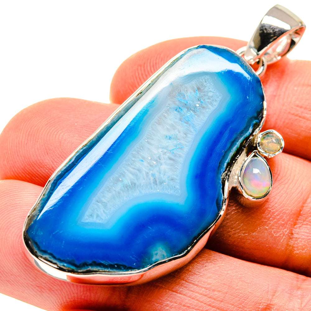 Blue geode slice pendant in silver with multicolor opal drop details