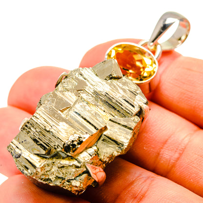 Pyrite crystal pendant with round citrine gemstone and sterling silver bail, close-up