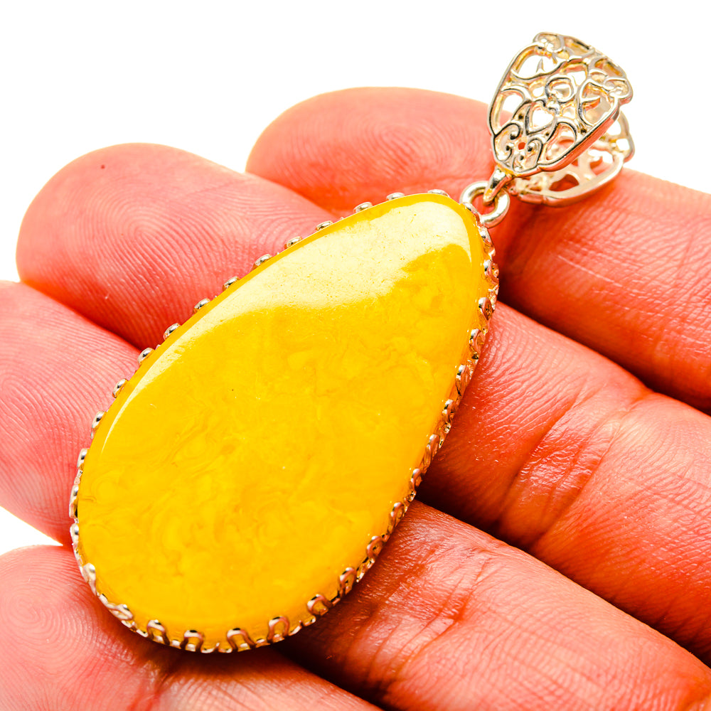 Yellow teardrop amber pendant with 925 sterling silver setting and bail