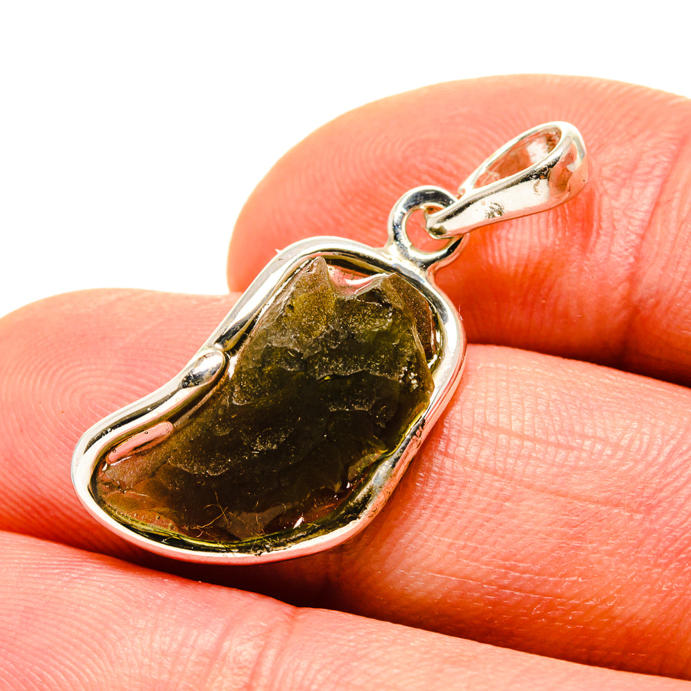 Sterling silver Moldavite pendant close-up on dark green stone in bezel
