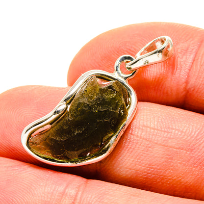 Sterling silver Moldavite pendant close-up on dark green stone in bezel