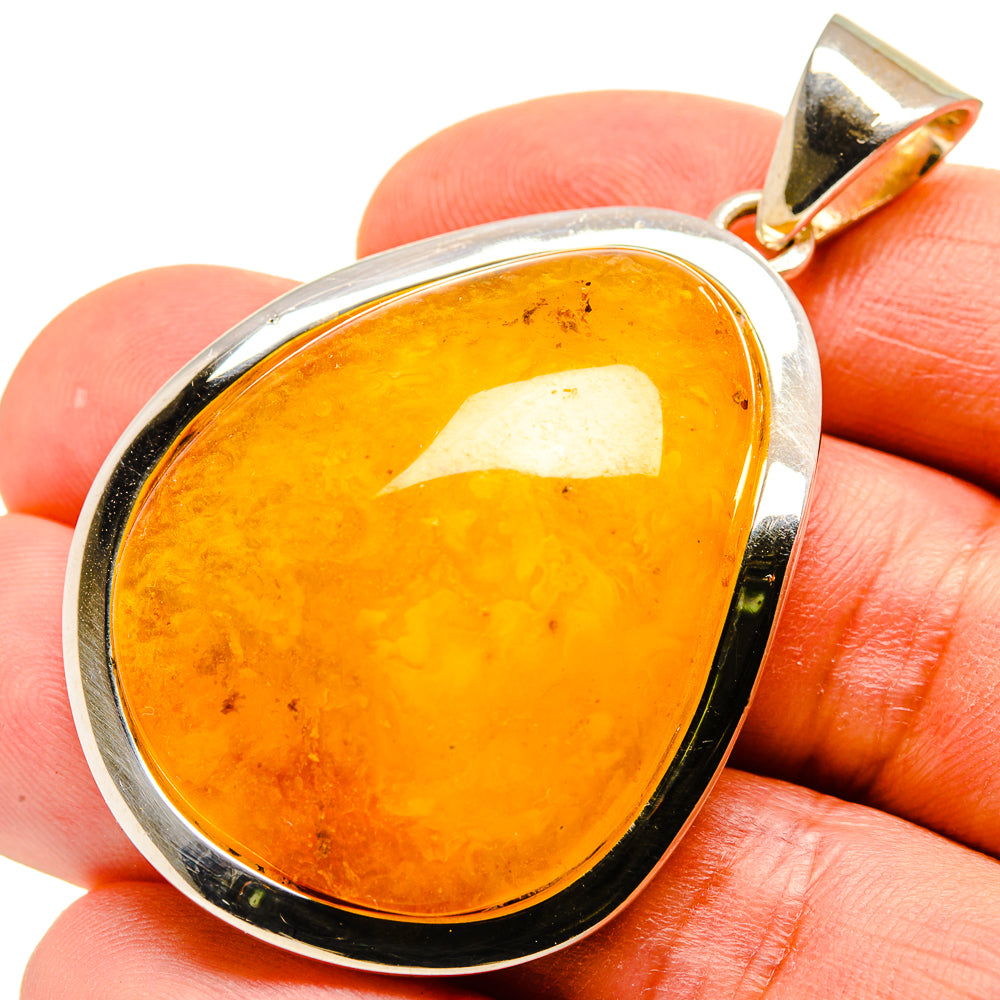 Amber teardrop pendant in polished 925 sterling silver with gold-toned bail
