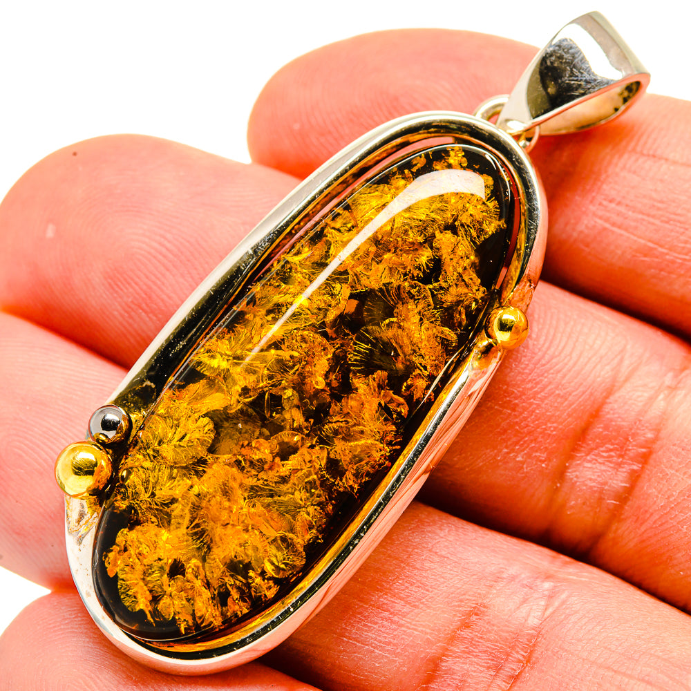 Oval amber pendant in 925 sterling silver bezel with gold bail