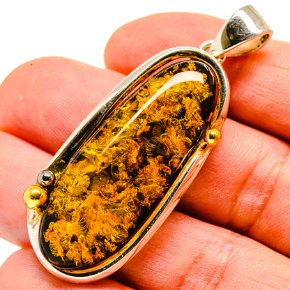 Oval amber pendant in 925 sterling silver bezel with gold bail