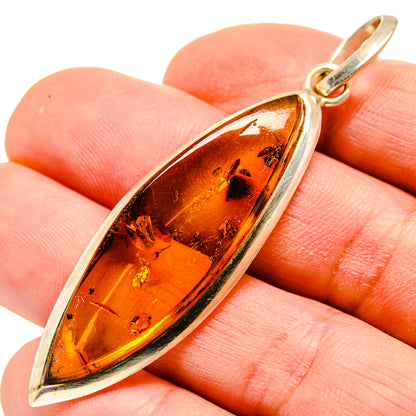 Amber pendant with marquise cabochon in 925 sterling silver setting and bail