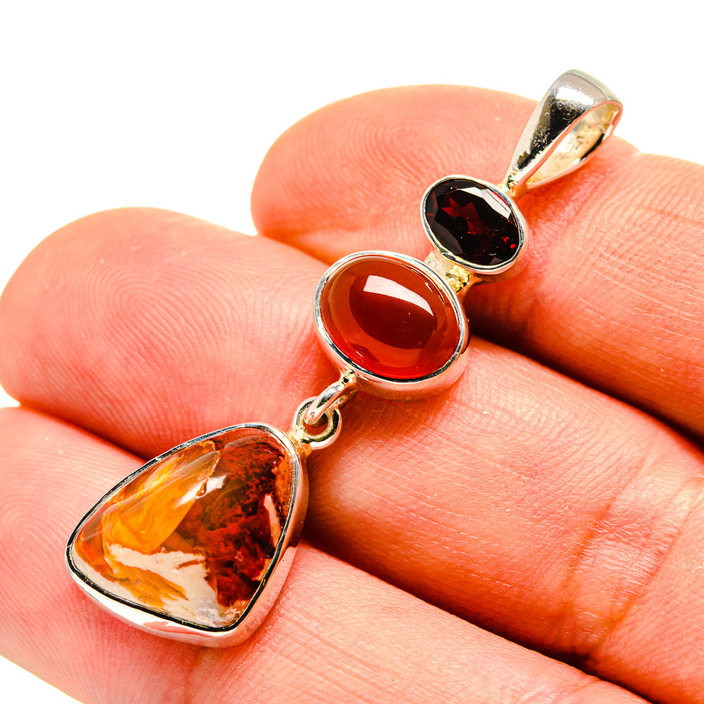 Sterling silver gemstone pendant with amber and dark red teardrop cabochons on chain